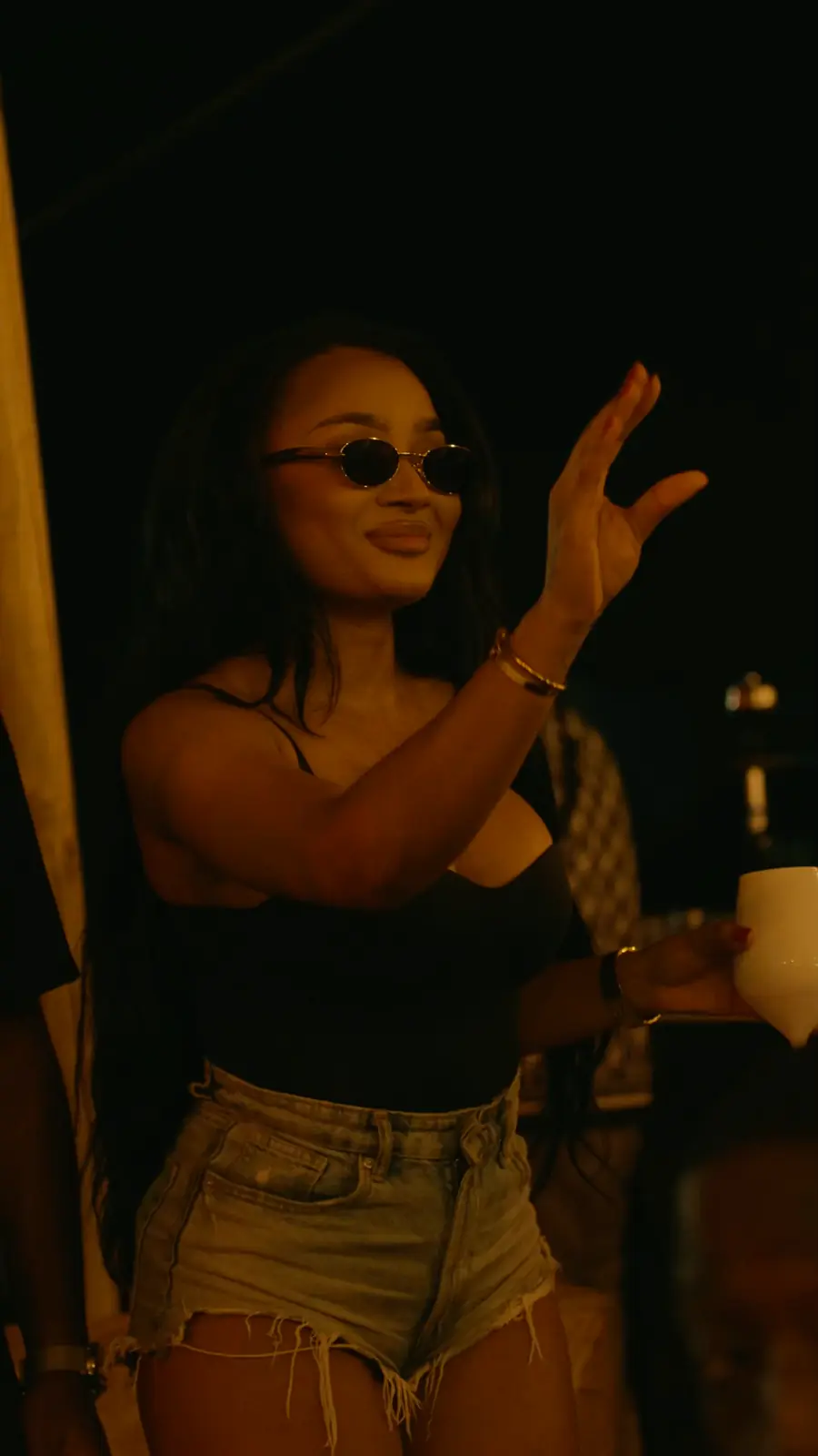 A woman in sunglasses dancing at Heaven, the rooftop terrace party in Brussels.