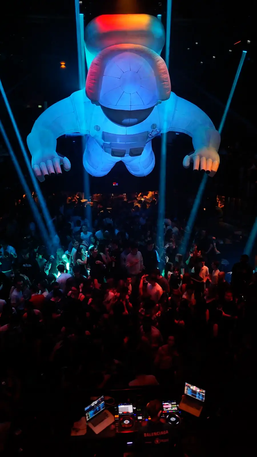 A giant inflatable astronaut hanging over the DJ booth and the crowd at Space, Brussels.