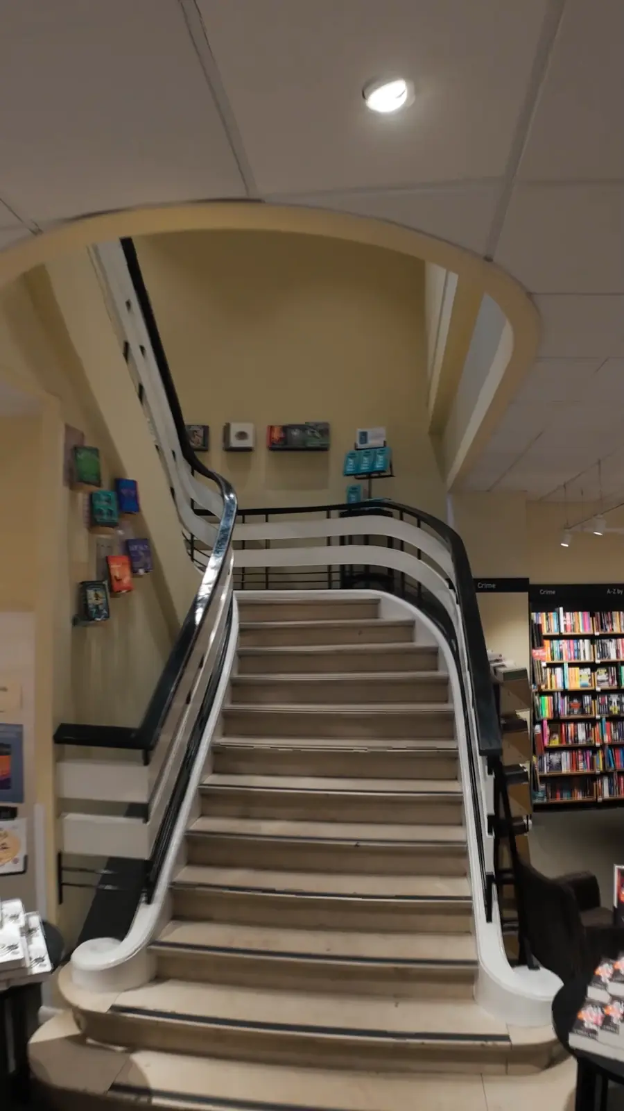 Book tables and the curved staircase inside the Waterstones bookshop in Brussels.